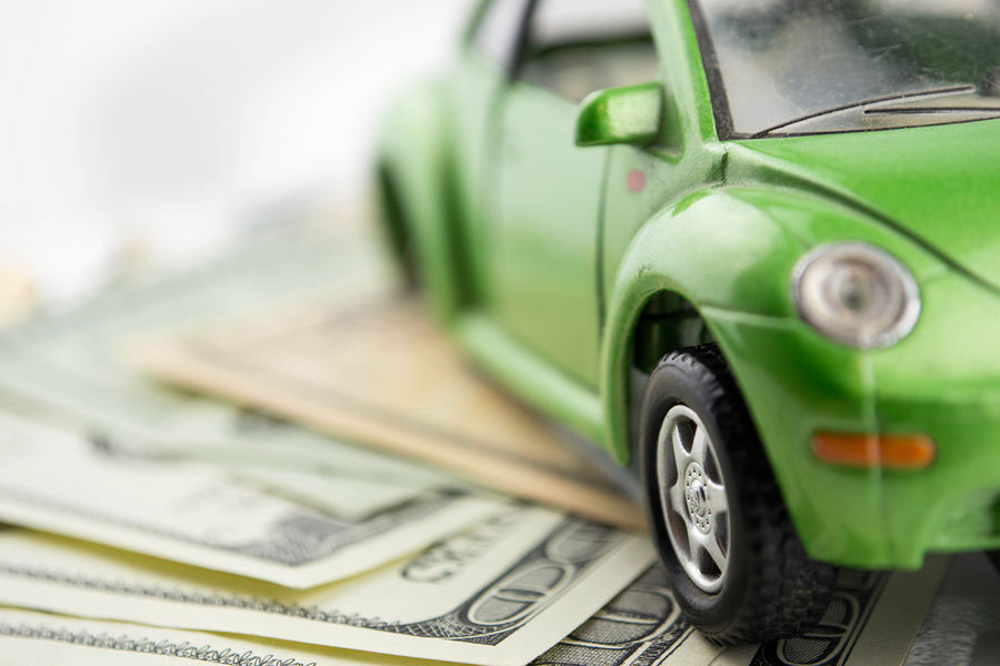 bigstock-Toy-car-and-money-over-white--49217057