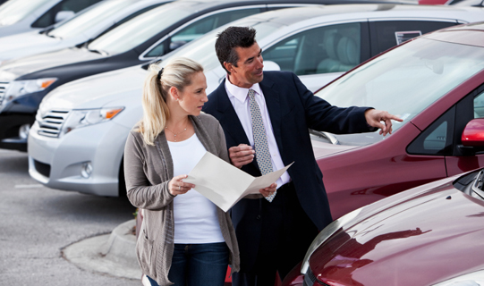 Car salesman with a customer