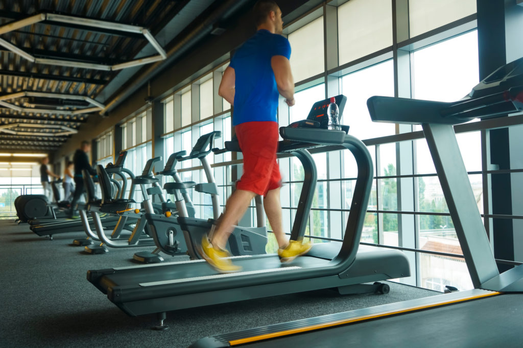 asian man jogging on threadmill