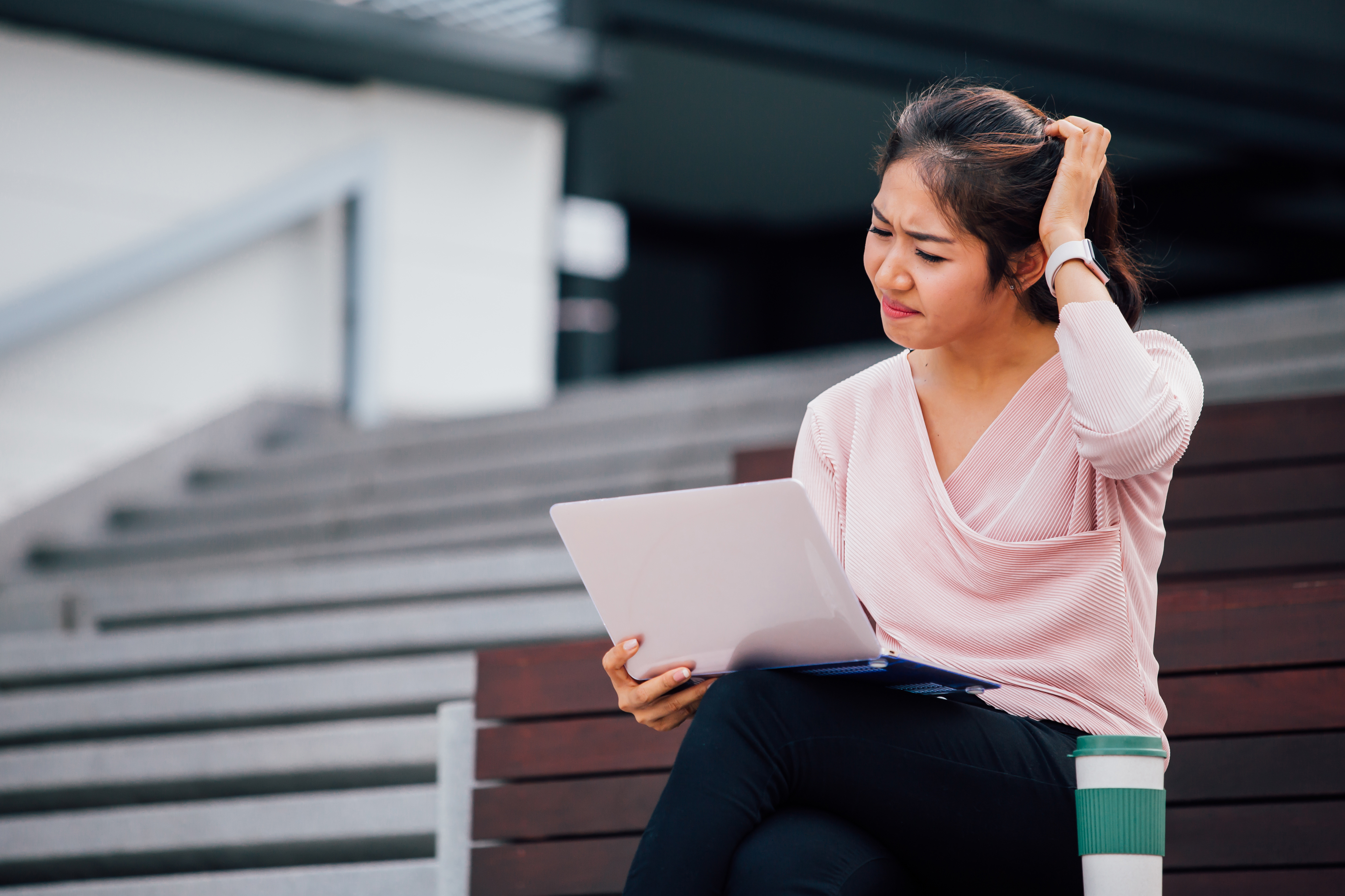 Asian woman worried about the yearly hassle of road tax and insurance renewal