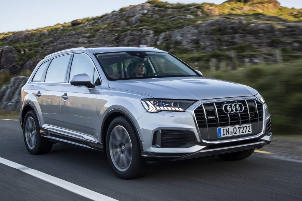 Audi Q7 driving by mountain landscape