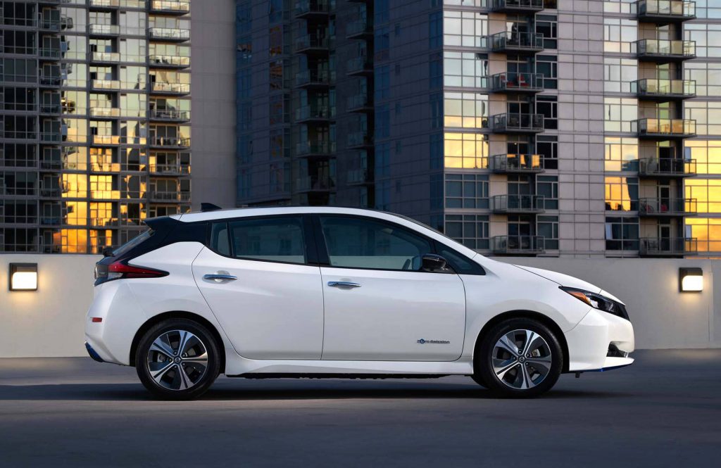 Nissan LEAF driving by the city skyline