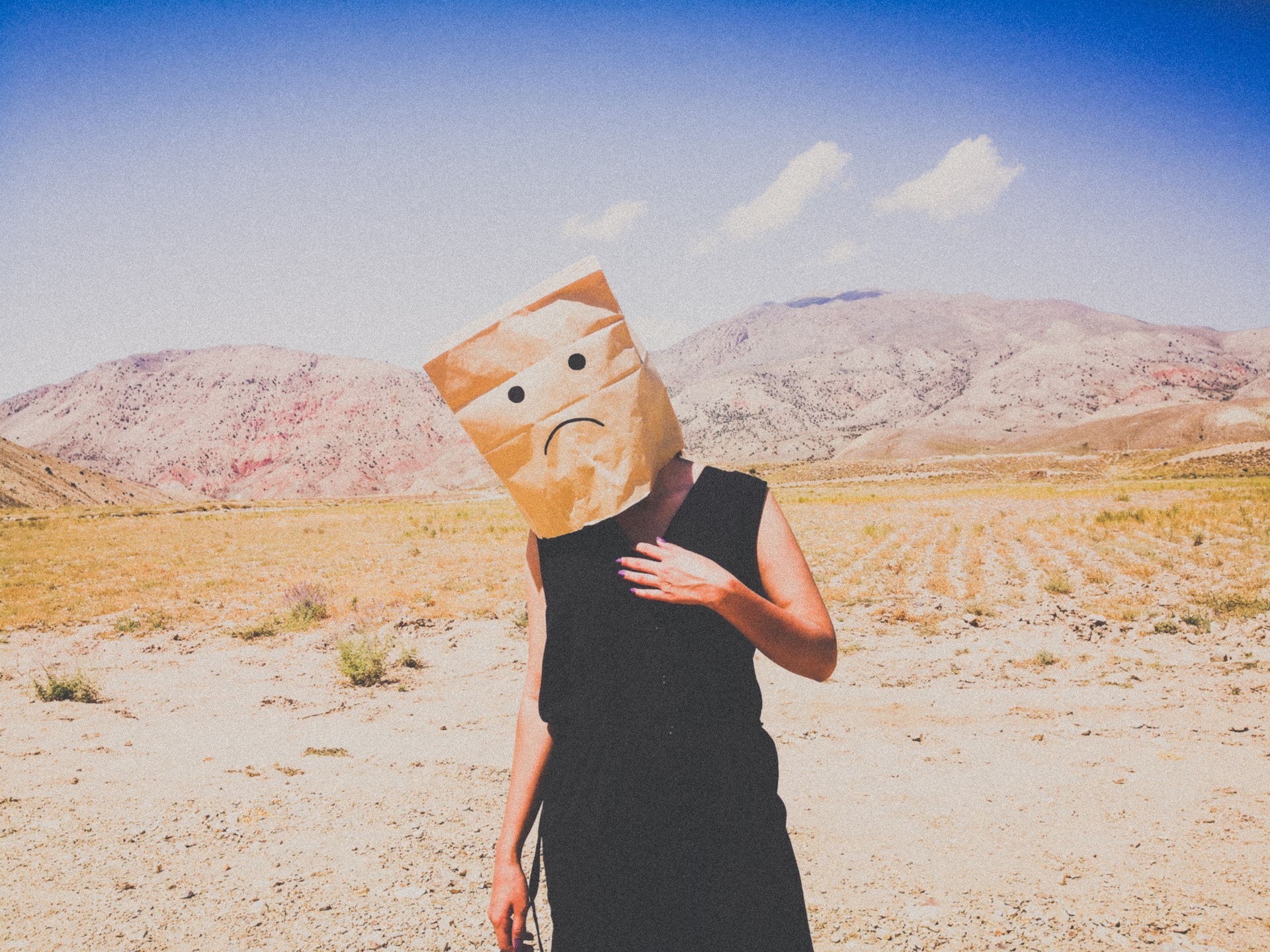 Sad face on paper bag over woman's head after license revoked