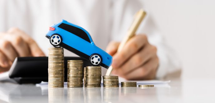 Toy car balancing on stack of coins