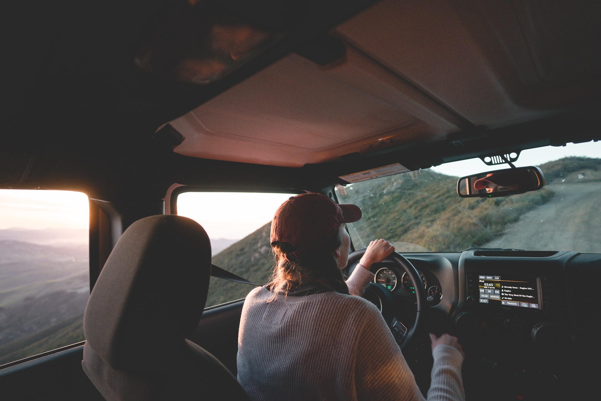 woman driving next to cliff