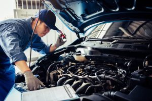 Mechanic inspecting car, car service